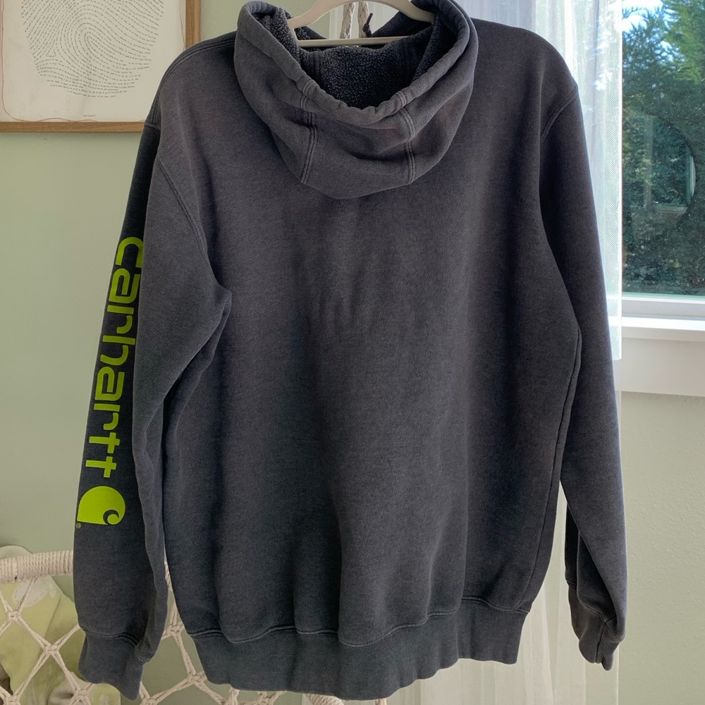 Medium Carhartt sweater, dark grey with a neon green sleeve symbol.
